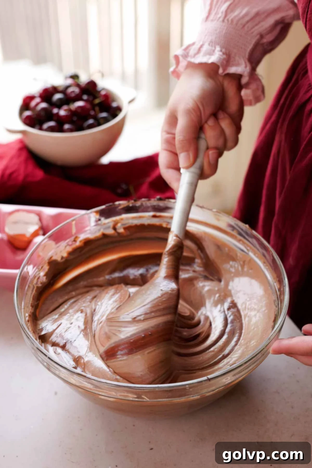 folding chocolate ganache into cheesecake batter
