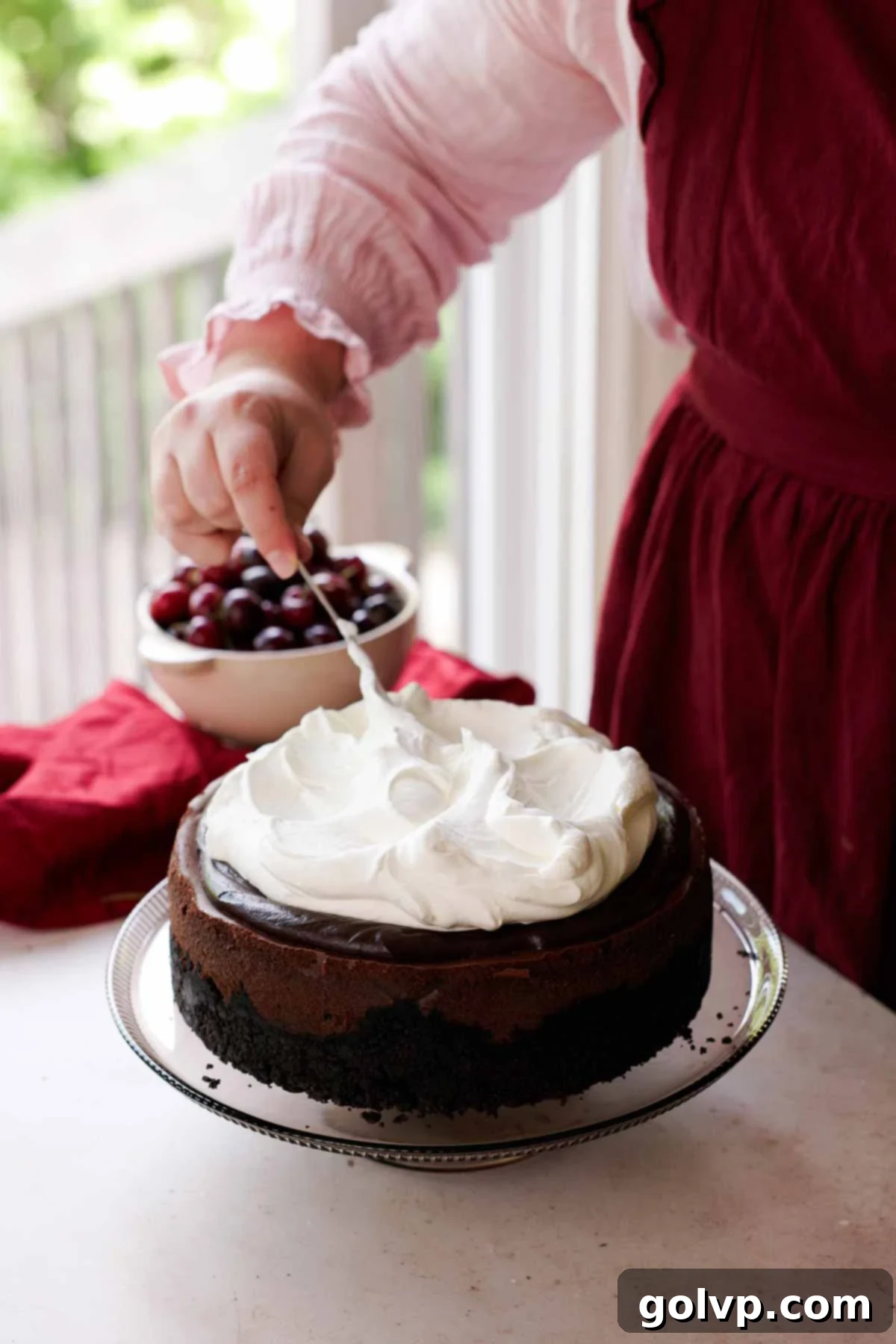 topping cheesecake with whipped cream
