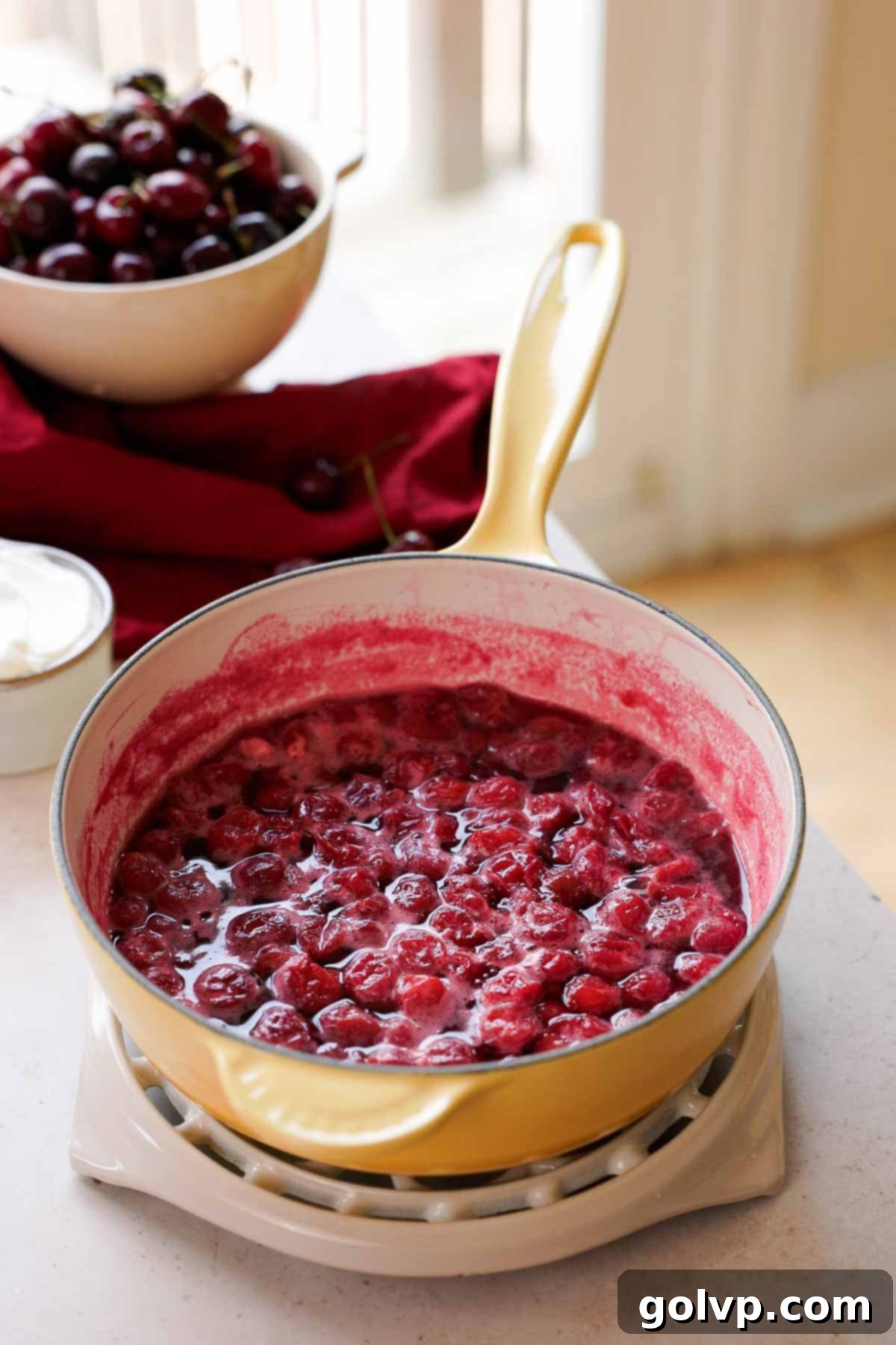 simmering tart cherries in a saucepan
