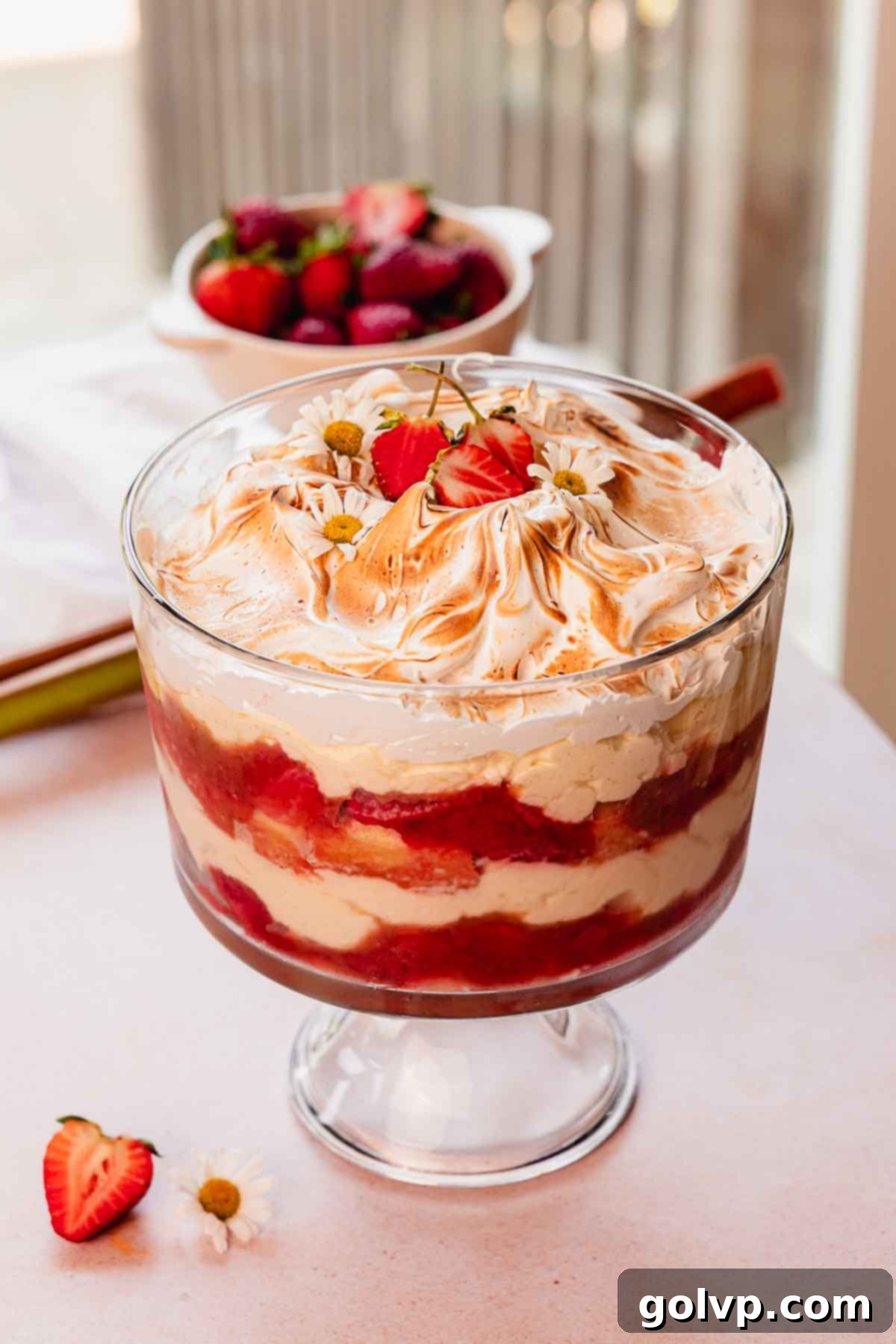 rhubarb trifle layered with custard, rhubarb and fresh strawberry compote, and toasted meringue