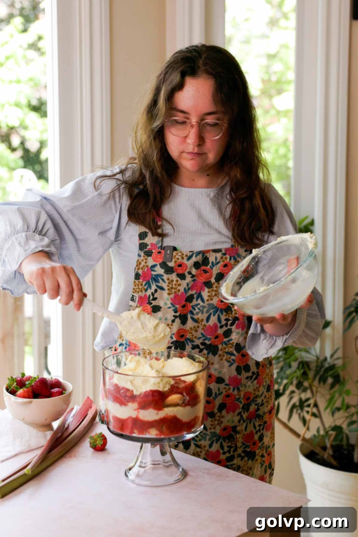 layering whipped custard in rhubarb trifle dish