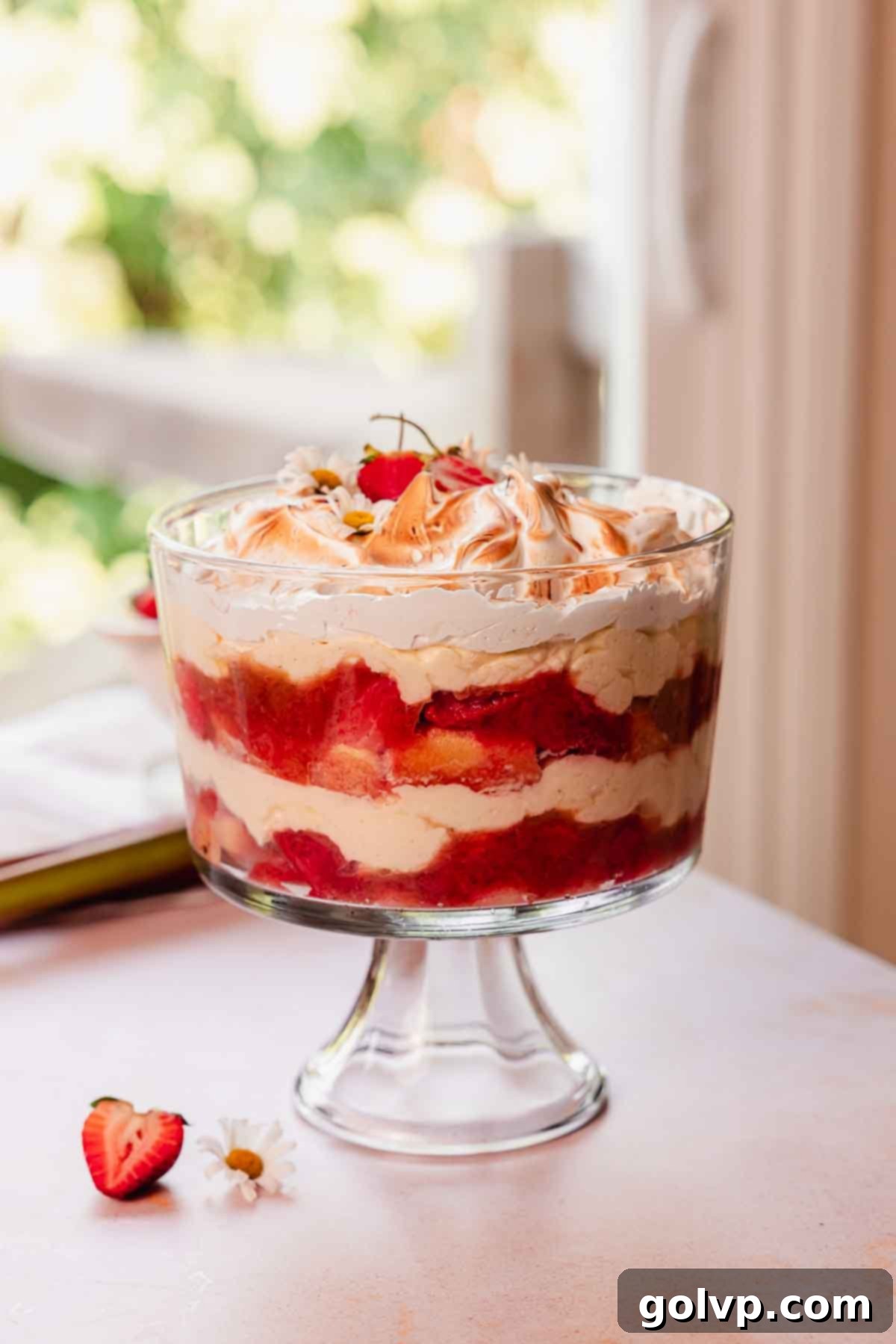 rhubarb trifle with custard layered in glass trifle container with toasted meringue on top