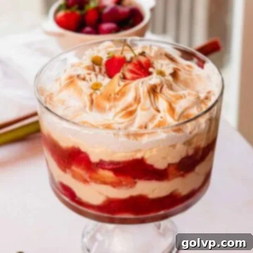 rhubarb trifle layered with custard, rhubarb and fresh strawberry compote, and toasted meringue