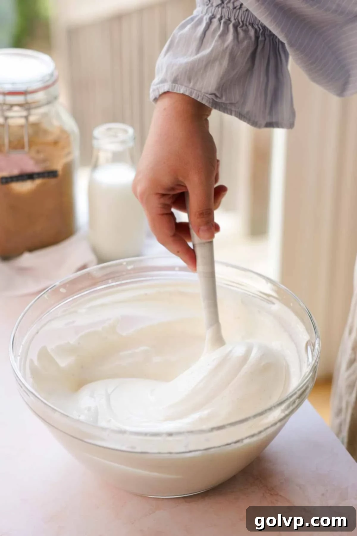 folding no churn vanilla ice cream with a spatula