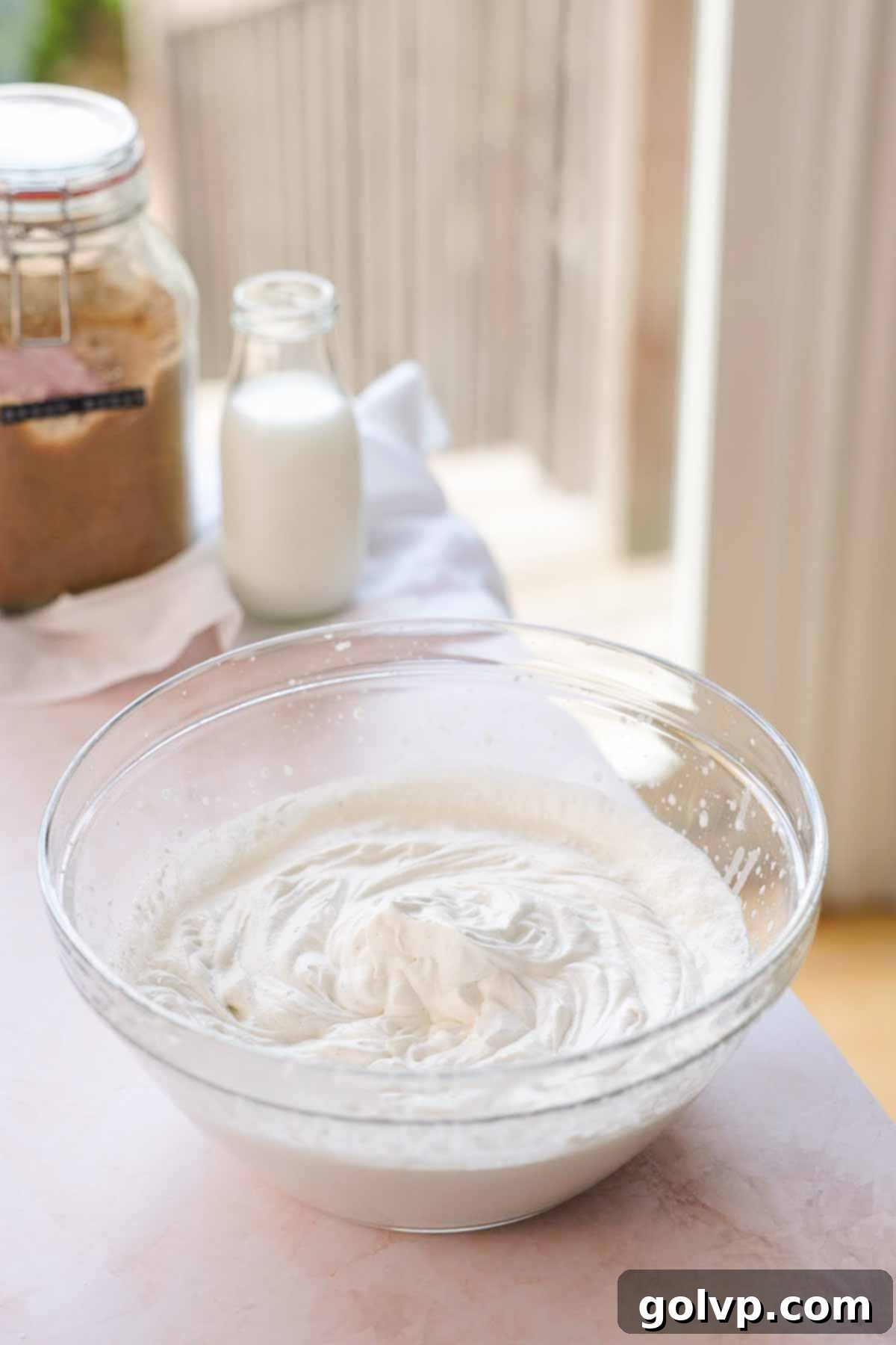 cream whipped to stiff peaks in a large glass bowl