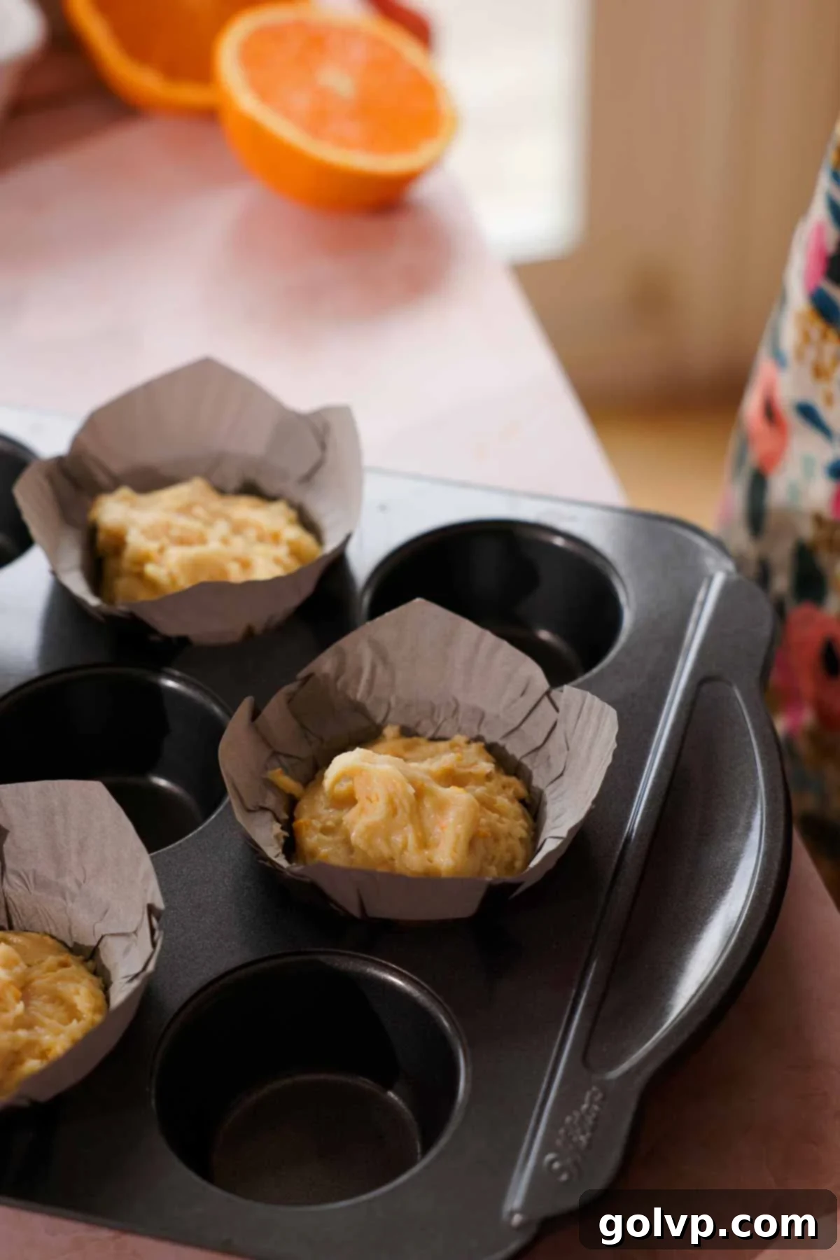 muffin batter scooped into lotus muffin liners