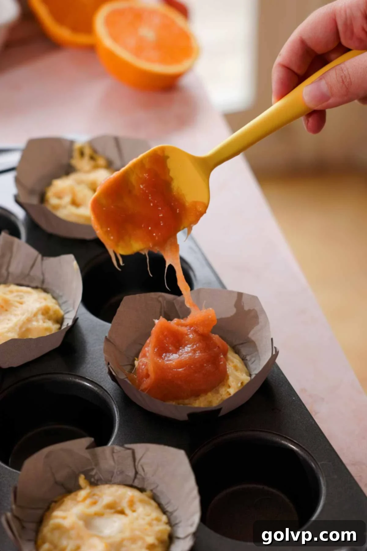 topping muffins with cooked rhubarb jam filling