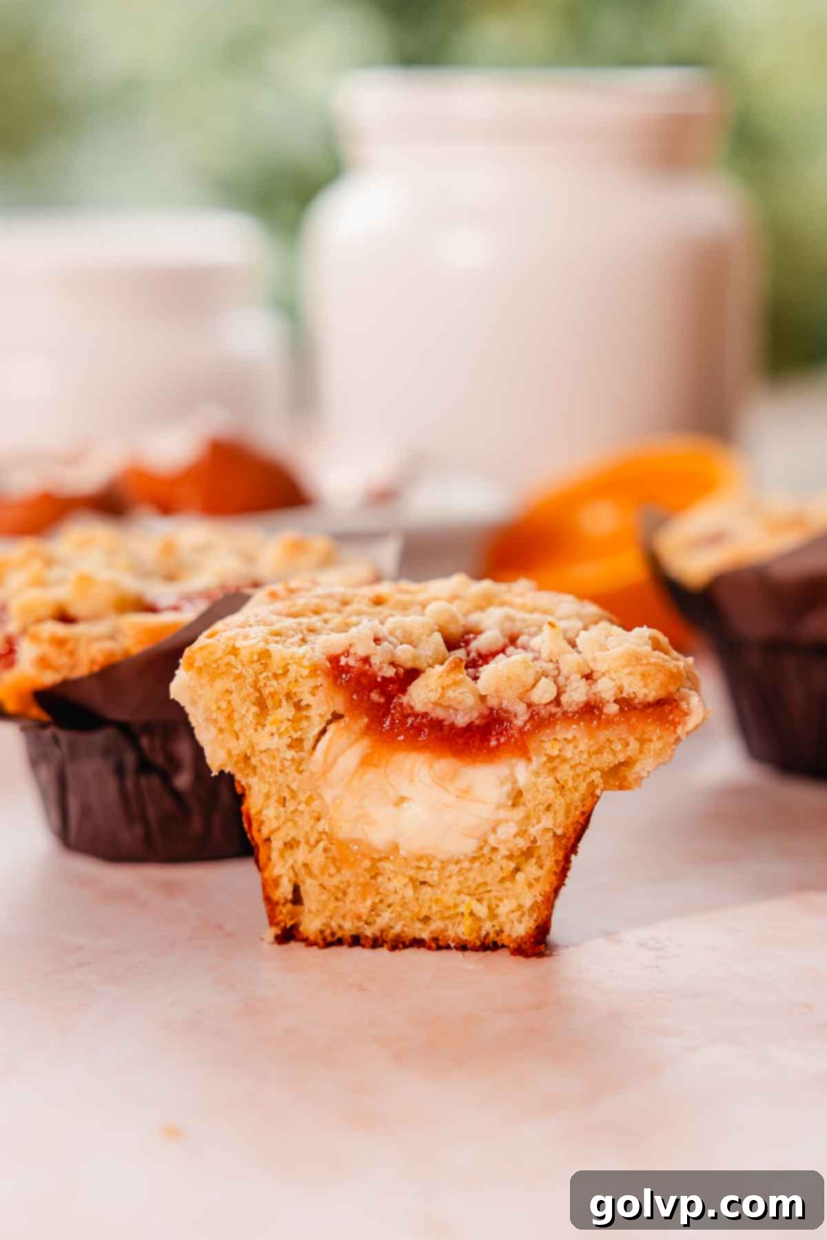 rhubarb muffin cut in half to show cream cheese filling