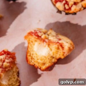 rhubarb muffins with cream cheese filling, rhubarb topping, and crumble