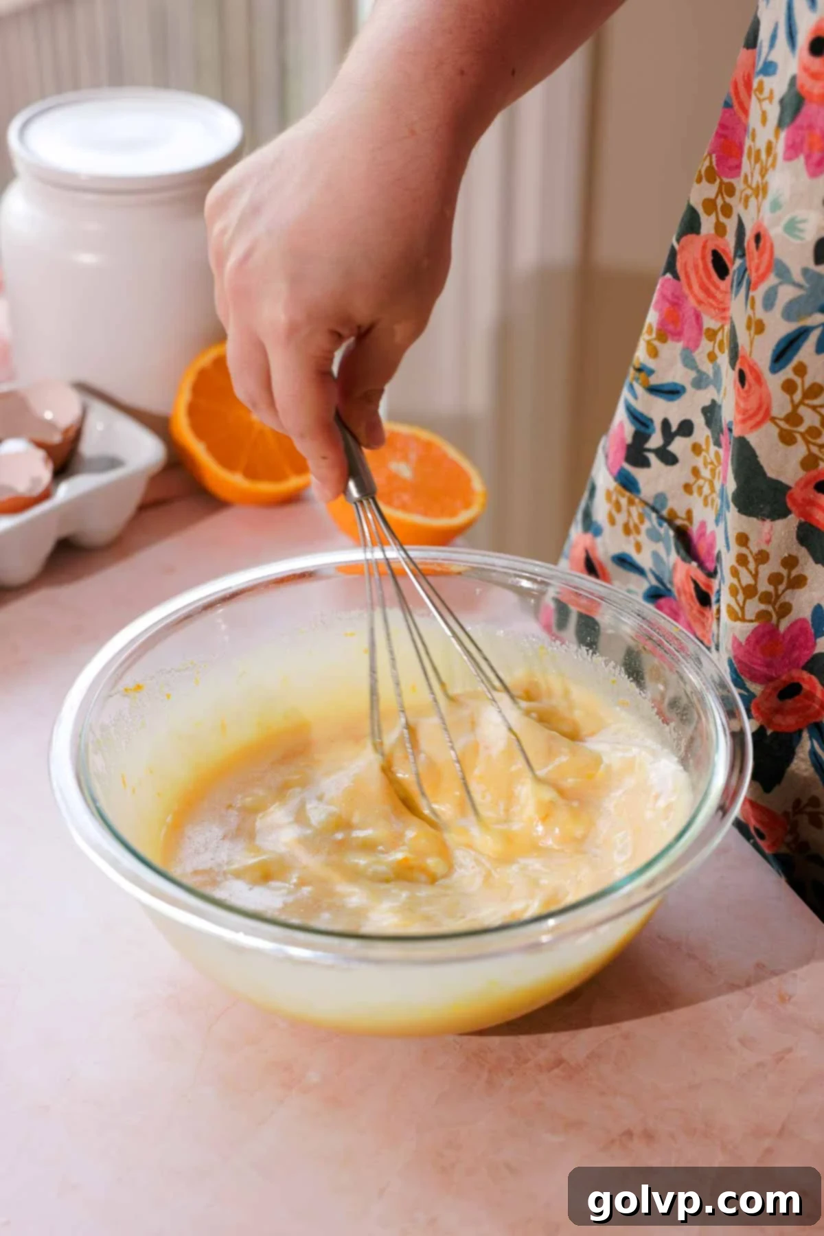 whisking rhubarb muffin wet ingredients in a bowl