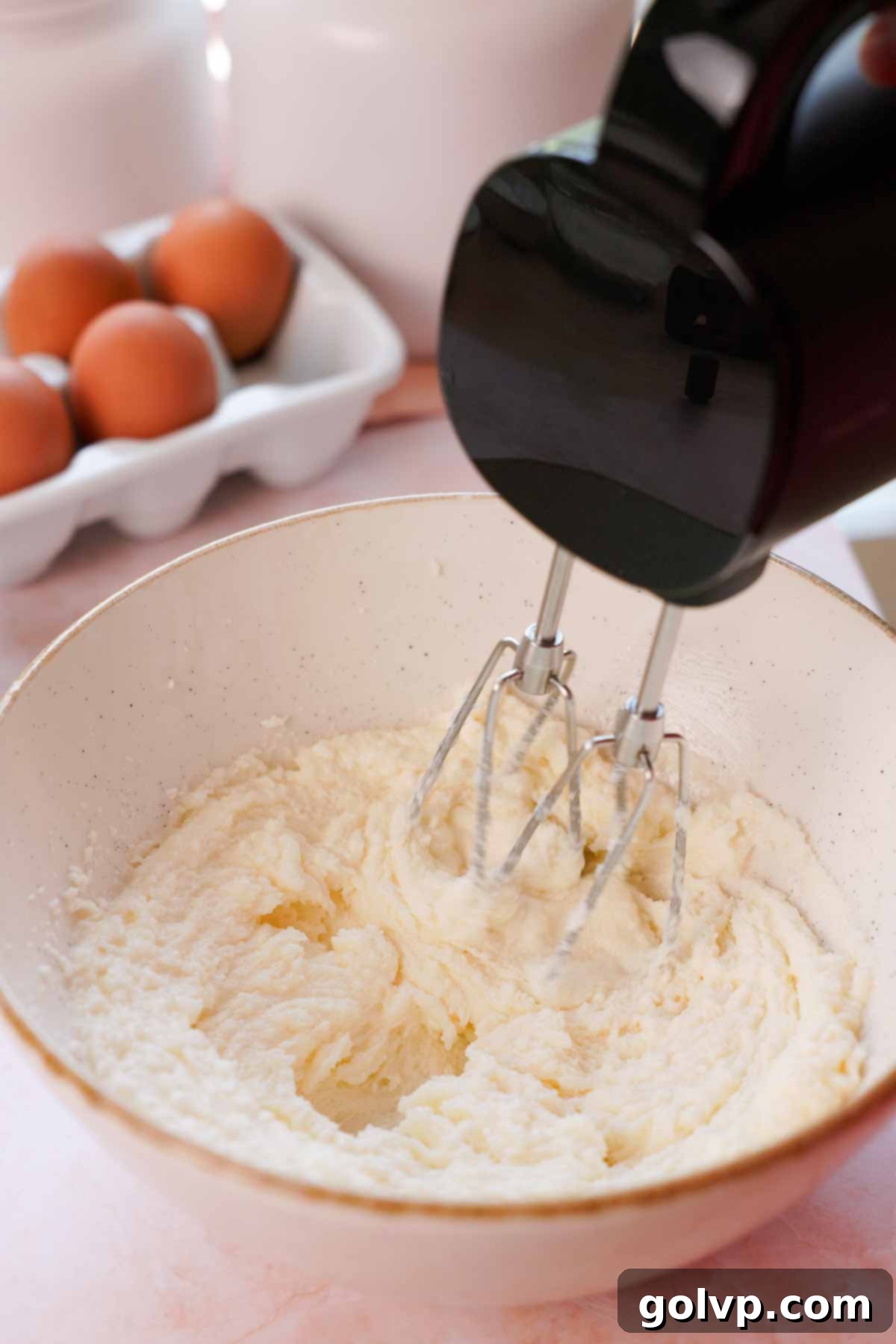 beating butter, oil, and sugar with electric mixer