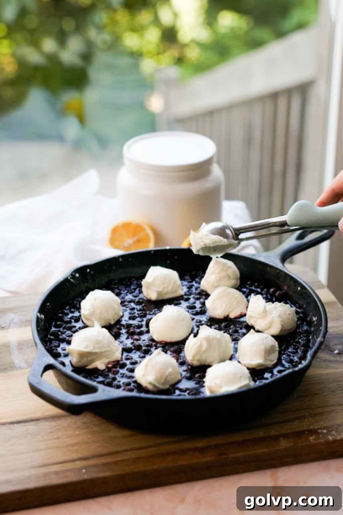 scooping cream cheese mixture into blueberry filling