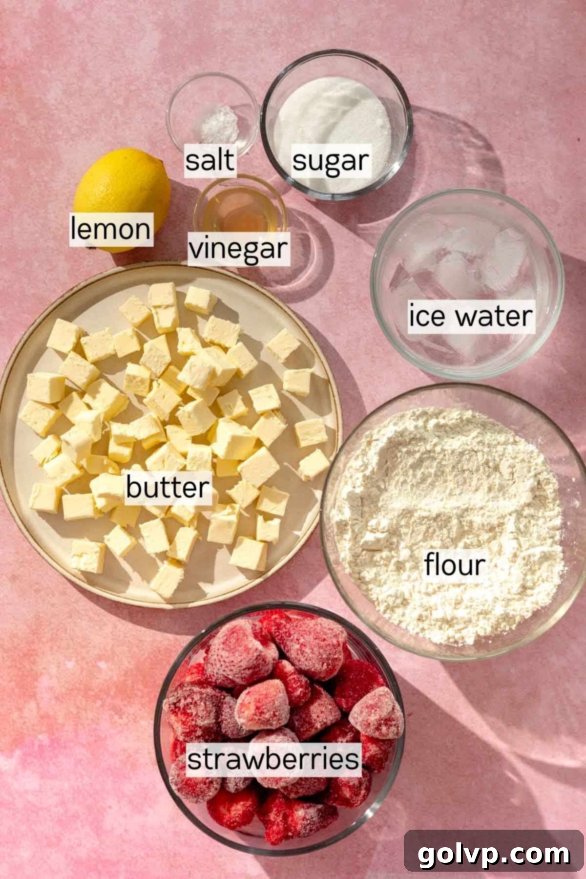 Individual bowls containing all the fresh ingredients required to make a homemade strawberry galette.