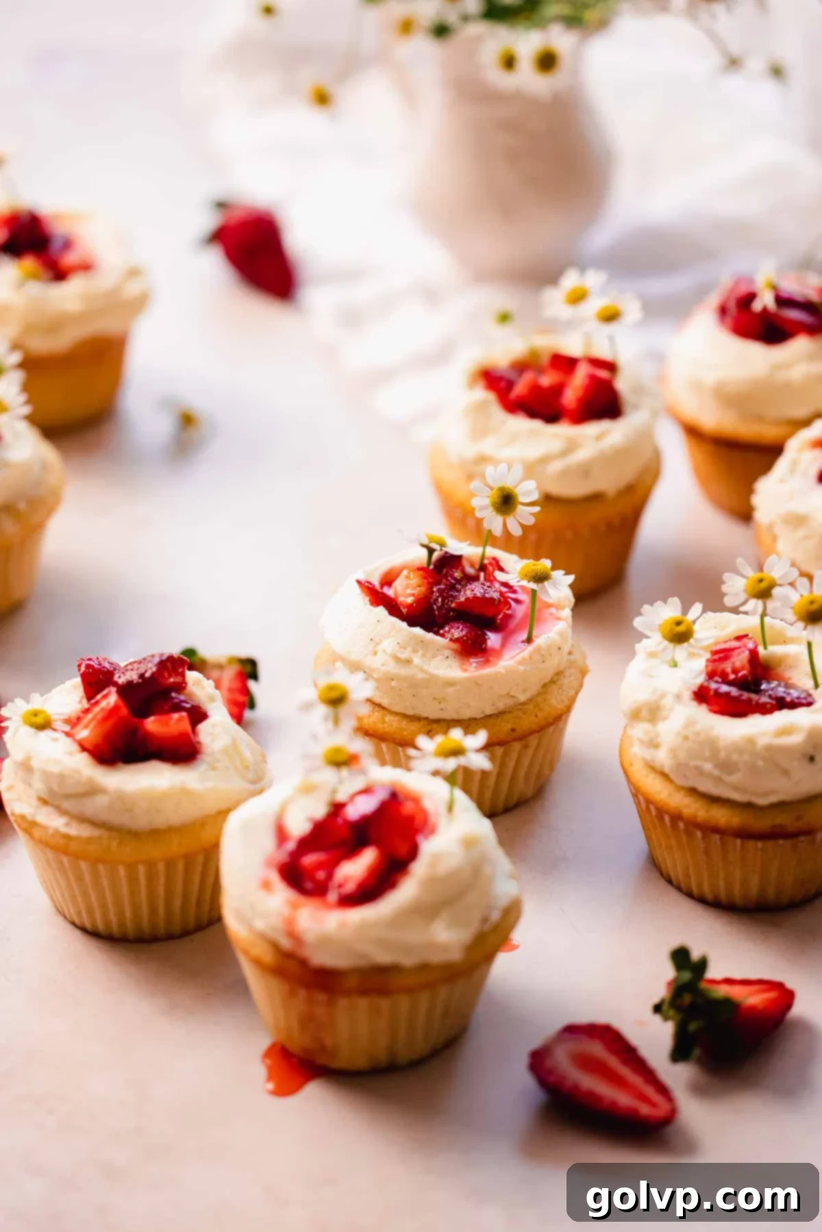 freshly made strawberry white chocolate cupcakes sitting on the table