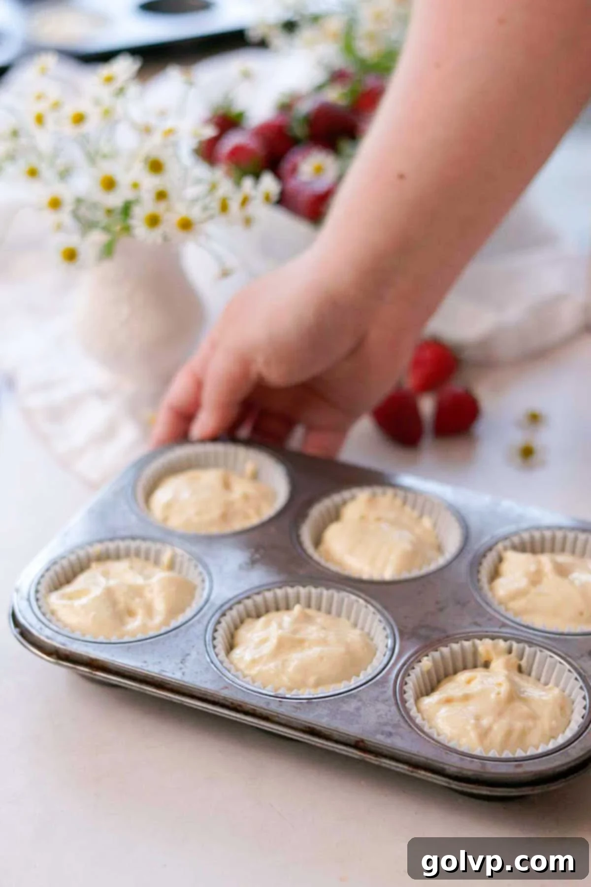 vanilla cupcake batter sitting in cupcake liners