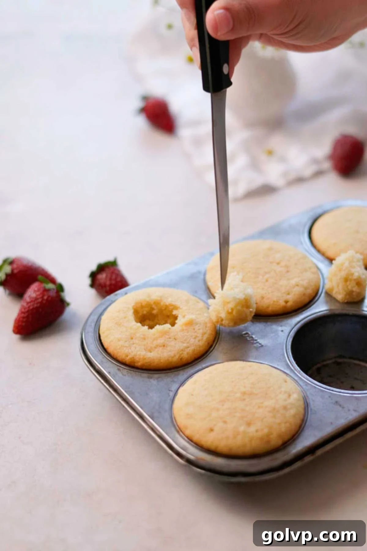 cutting out the centre of the cupcake with a knife