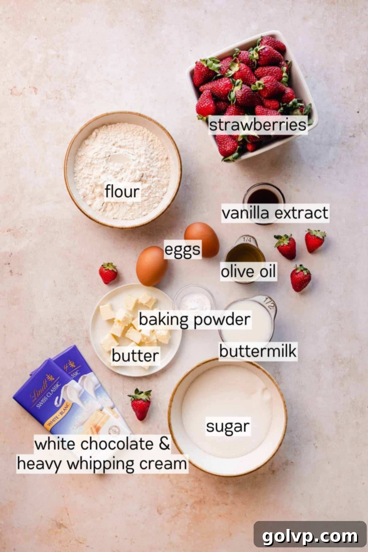 A collection of small bowls displaying all the key ingredients for strawberry white chocolate cupcakes, neatly arranged on a table.