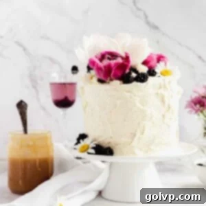 decorated cake with peonies and blackberries