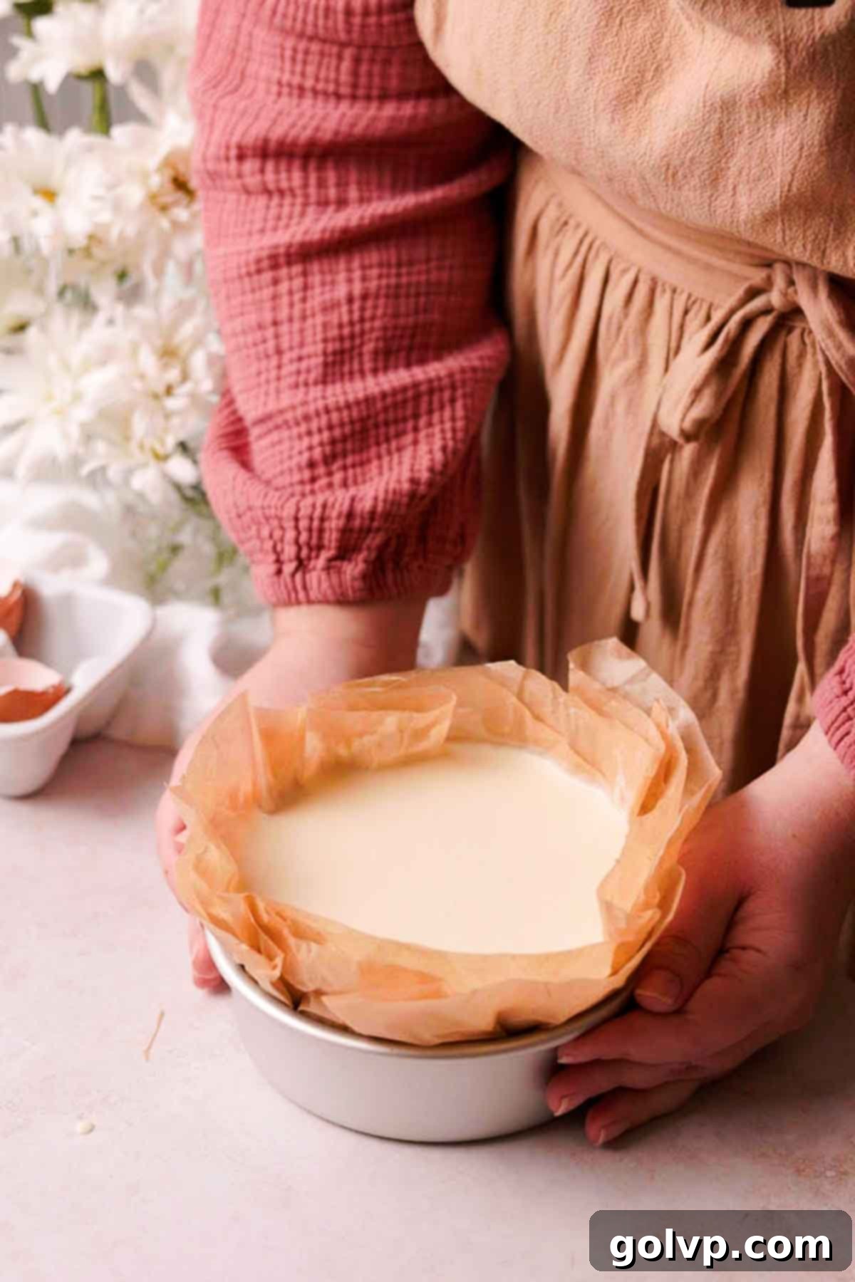 basque cheesecake batter in parchment paper lined baking pan
