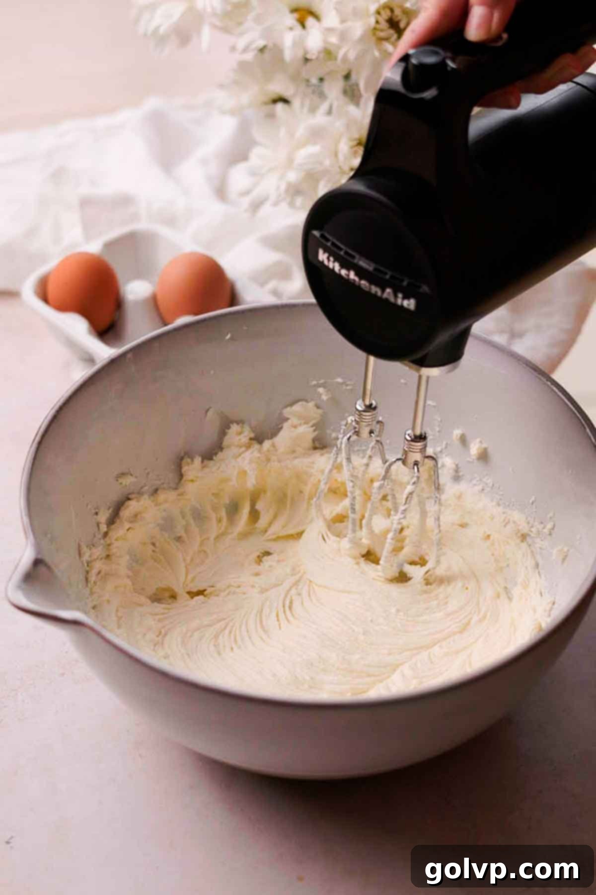 beating cream cheese and sugar together in large bowl with electric mixer