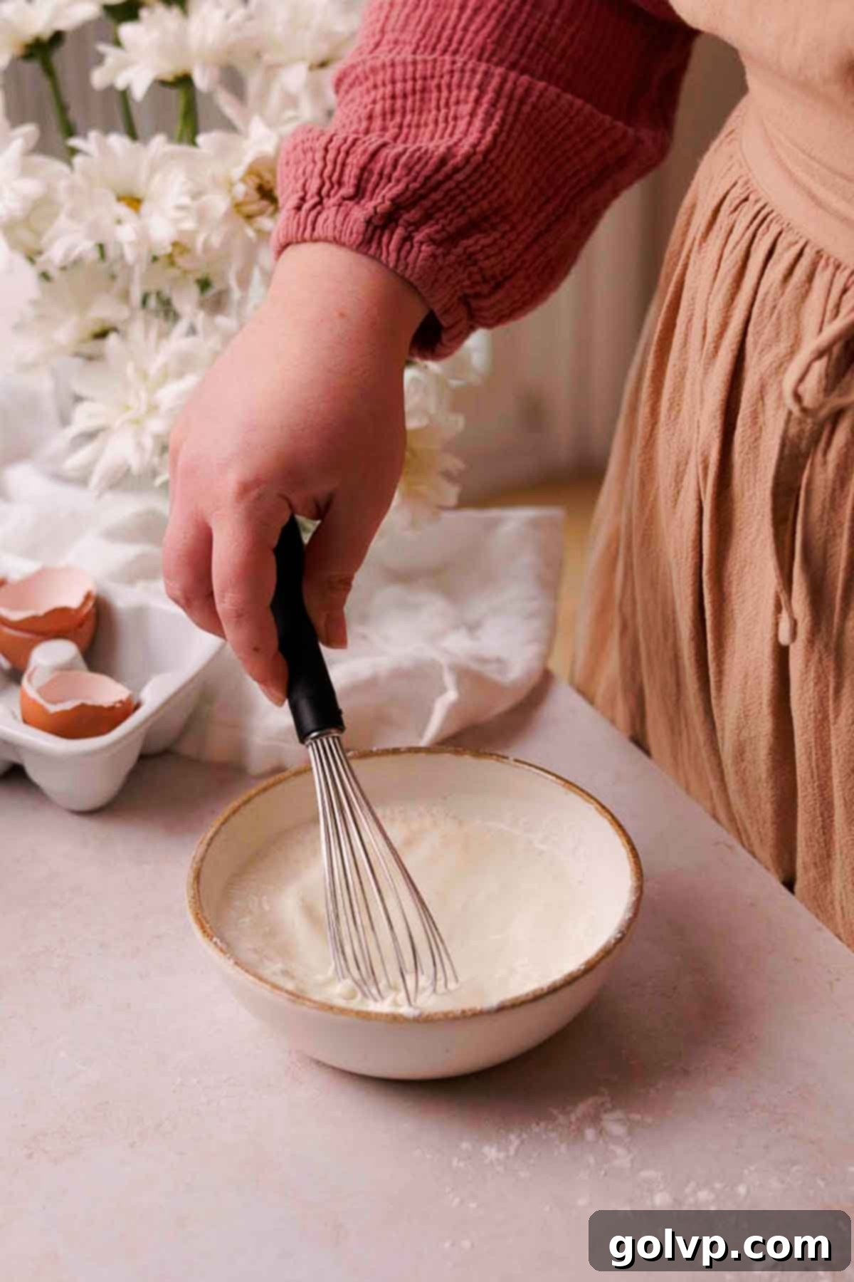 whisking potato starch and cream in bowl