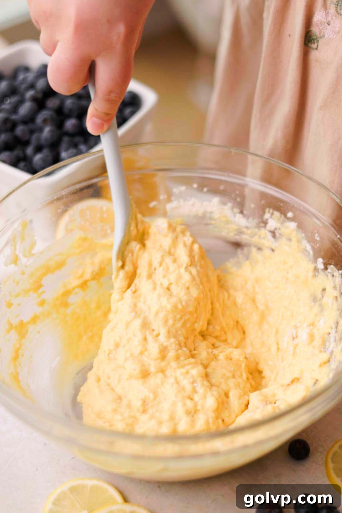 All-purpose flour being gently folded into the cupcake batter.