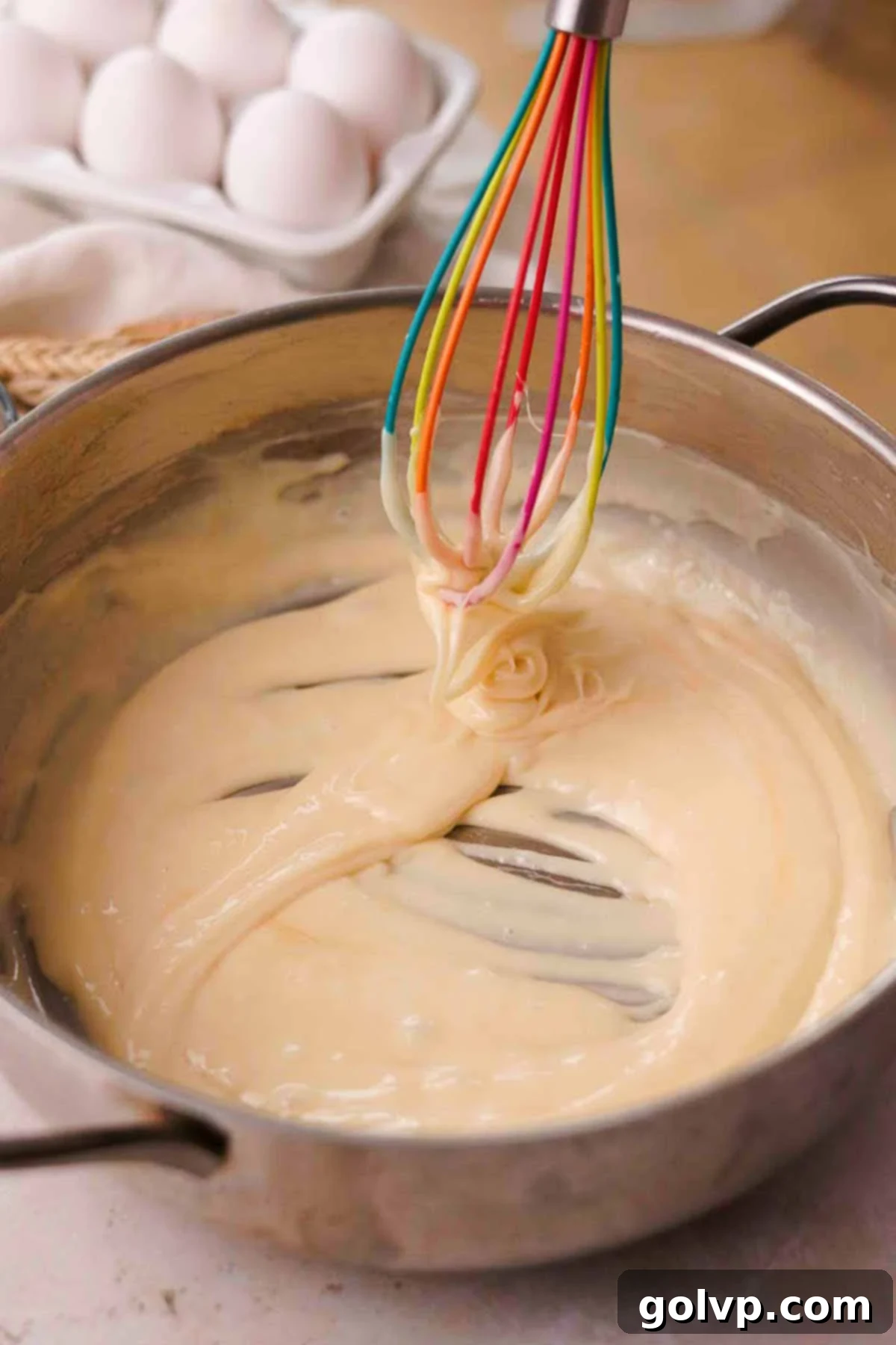 Vigorously whisking the no-bake cookie mixture in a saucepan until smooth