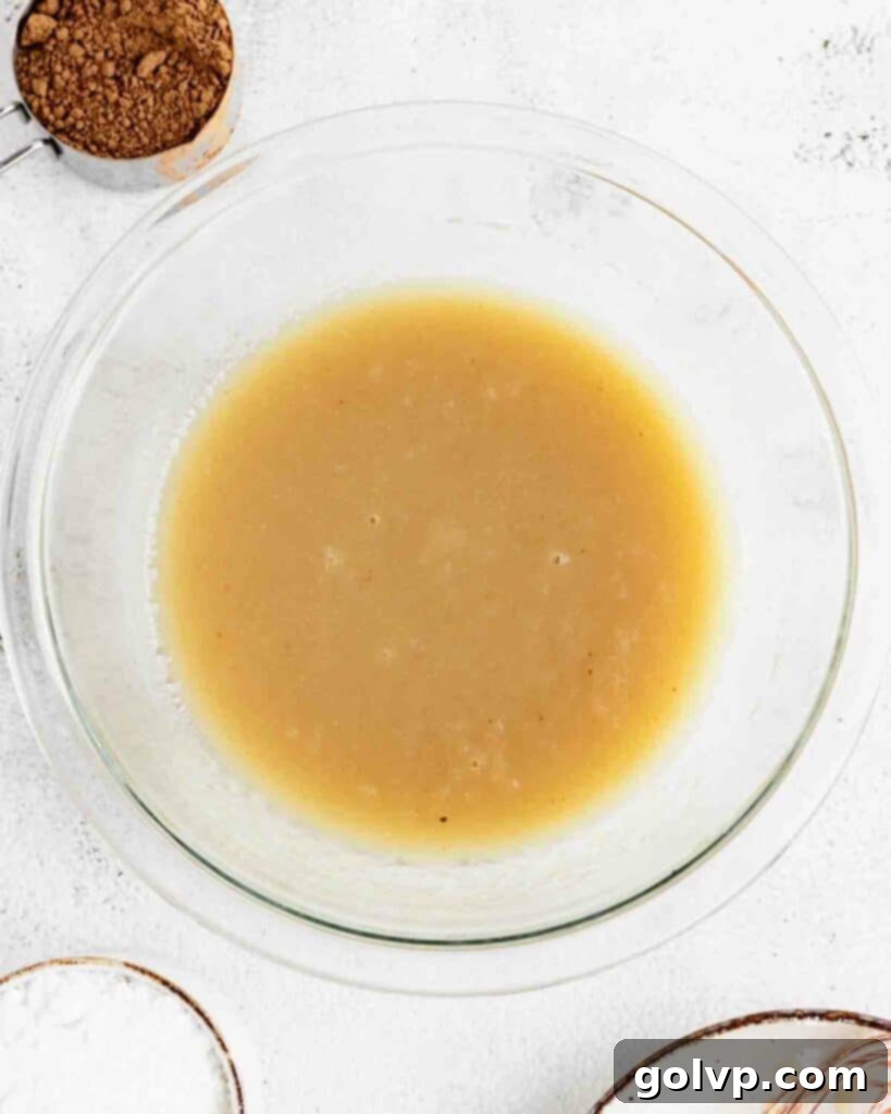 wet ingredients for the muffin batter being mixed in a bowl