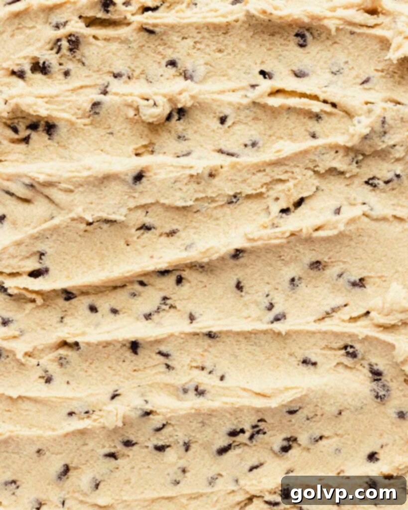 edible cookie dough spread on a sheet with chocolate chips