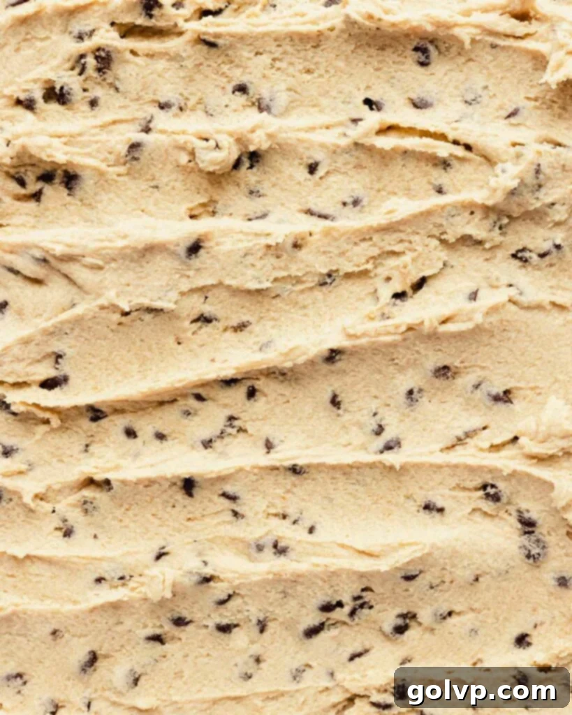 edible cookie dough spread on a sheet with chocolate chips