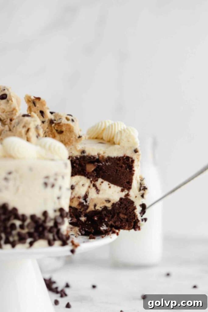 taking a slice of chocolate cake with layer of cookie dough and cookie dough buttercream, showing the texture