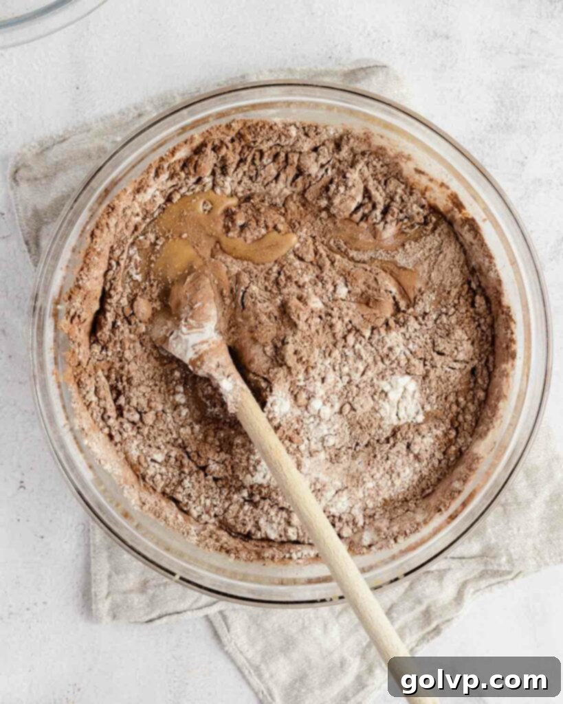 folding the brownie batter together gently to avoid overmixing