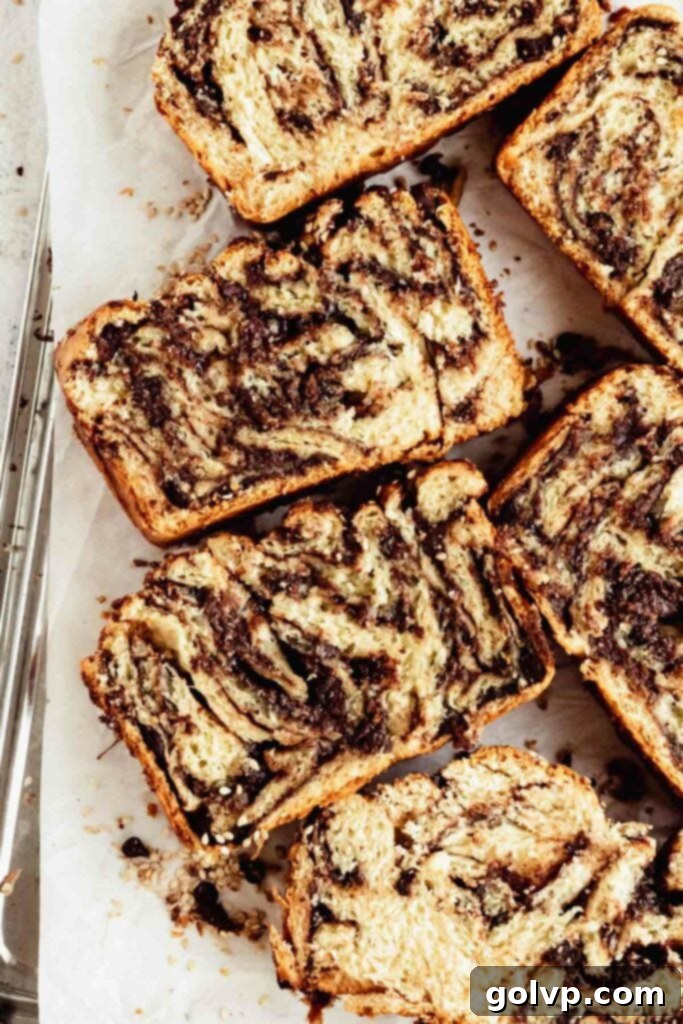 Easy No-Knead Chocolate Tahini Babka 2 Closeup of gooey chocolate tahini babka with golden crust and chocolate swirls visible