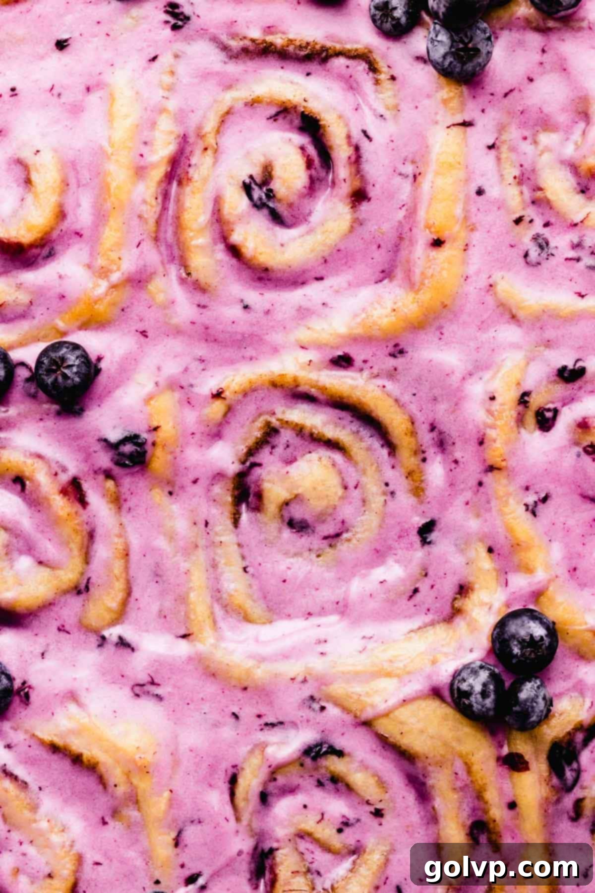 Gooey blueberry cinnamon rolls topped with a rich blueberry cream cheese glaze