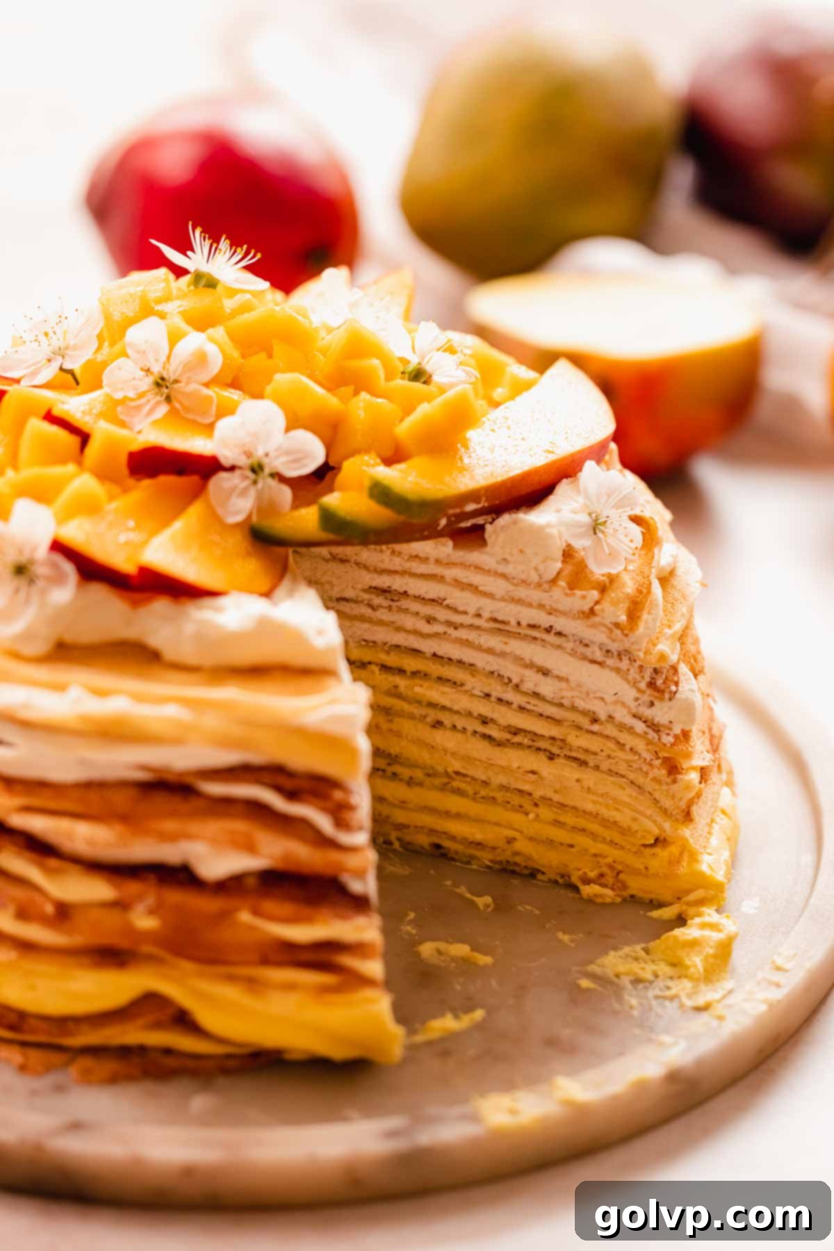 Decadent Mango Crepe Cake, Made Easy 19 A close-up view of a perfectly cut slice of mango crepe cake showcasing its layers.