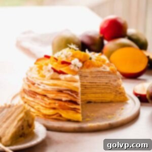 Decadent Mango Crepe Cake, Made Easy 21 A vibrant mango crepe cake with fresh mango slices on top.