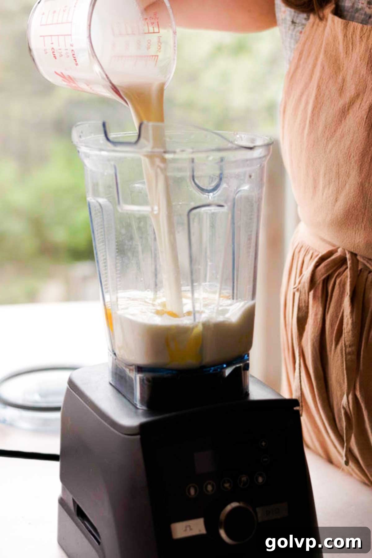 Decadent Mango Crepe Cake, Made Easy 5 Pouring crepe ingredients into a blender for easy mixing.