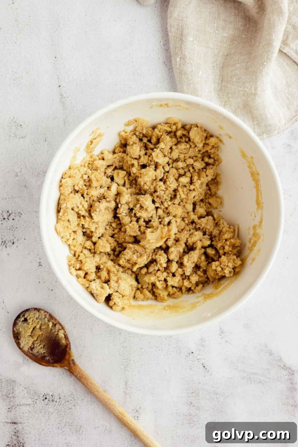 Mixing dry ingredients for crumble topping in a bowl.