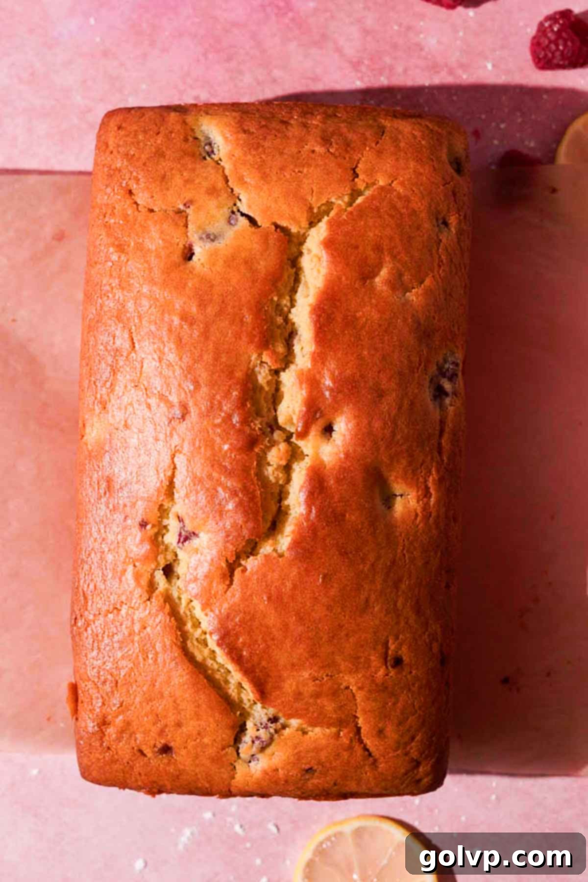 baked lemon raspberry loaf with crack along the top