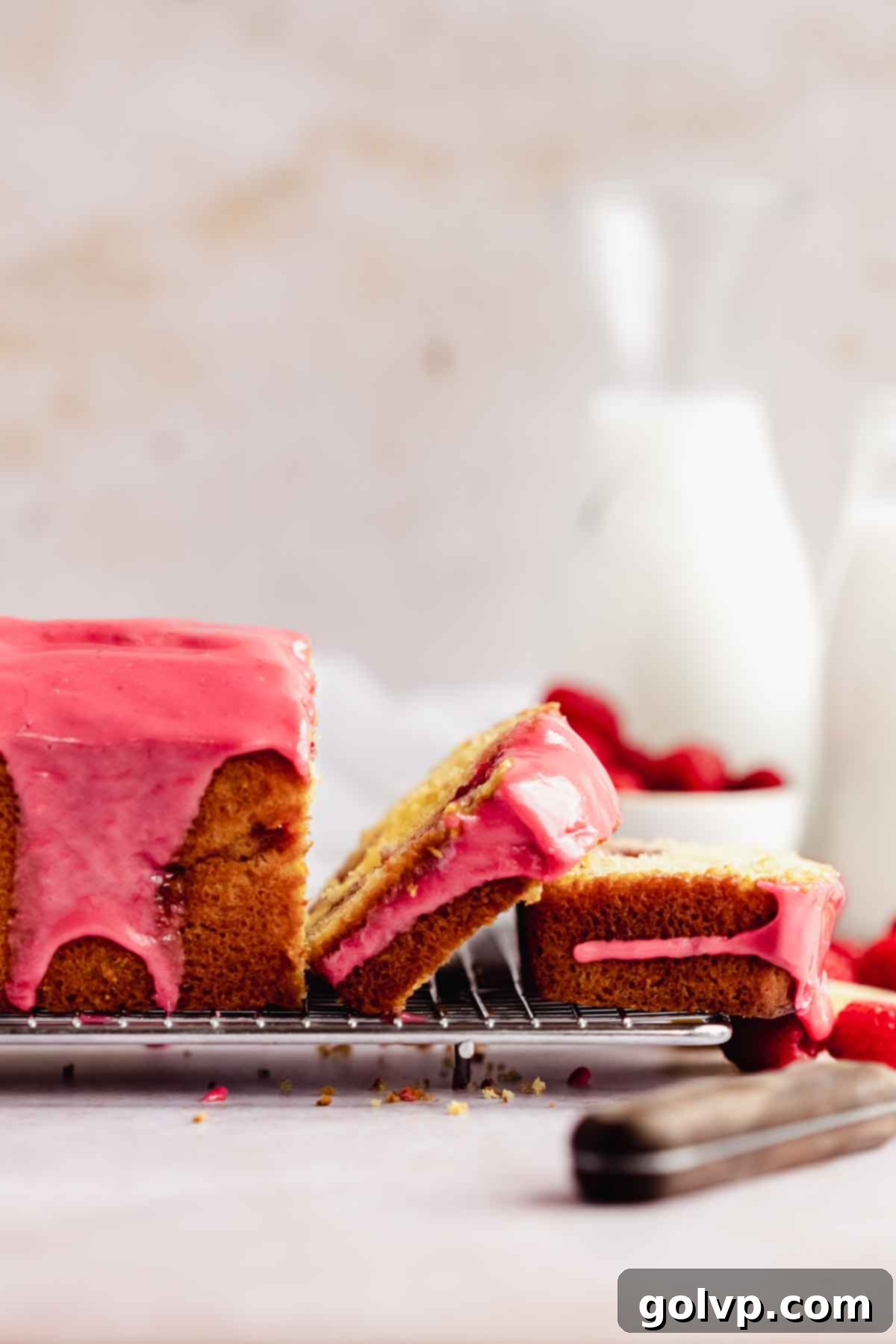 sliced lemon raspberry loaf sides to see the pink glaze dripping