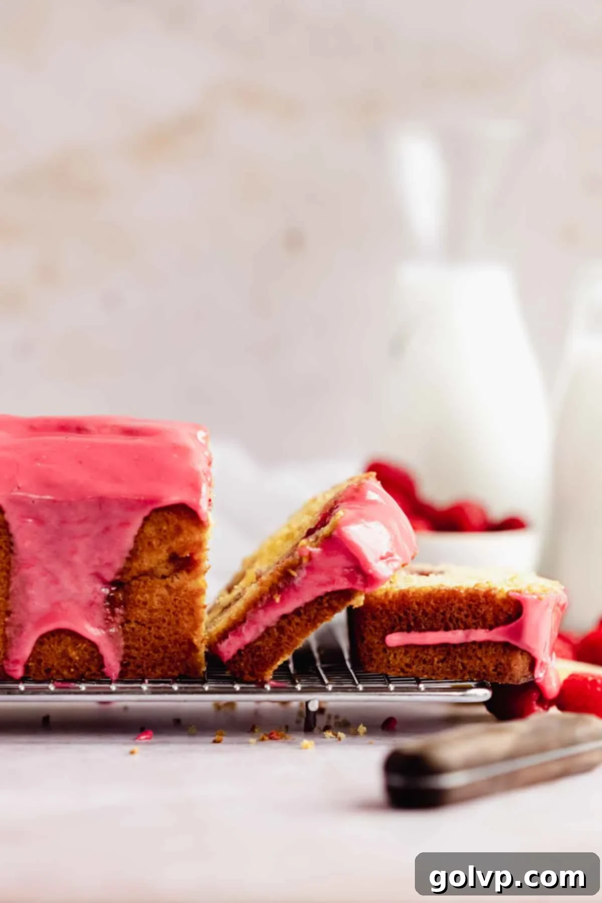 sliced lemon raspberry loaf sides to see the pink glaze dripping