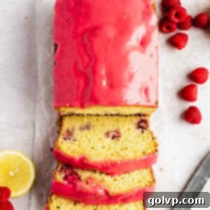 lemon raspberry loaf sliced with raspberry glaze on wax paper