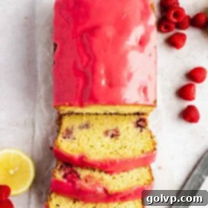 lemon raspberry loaf sliced with raspberry glaze on wax paper