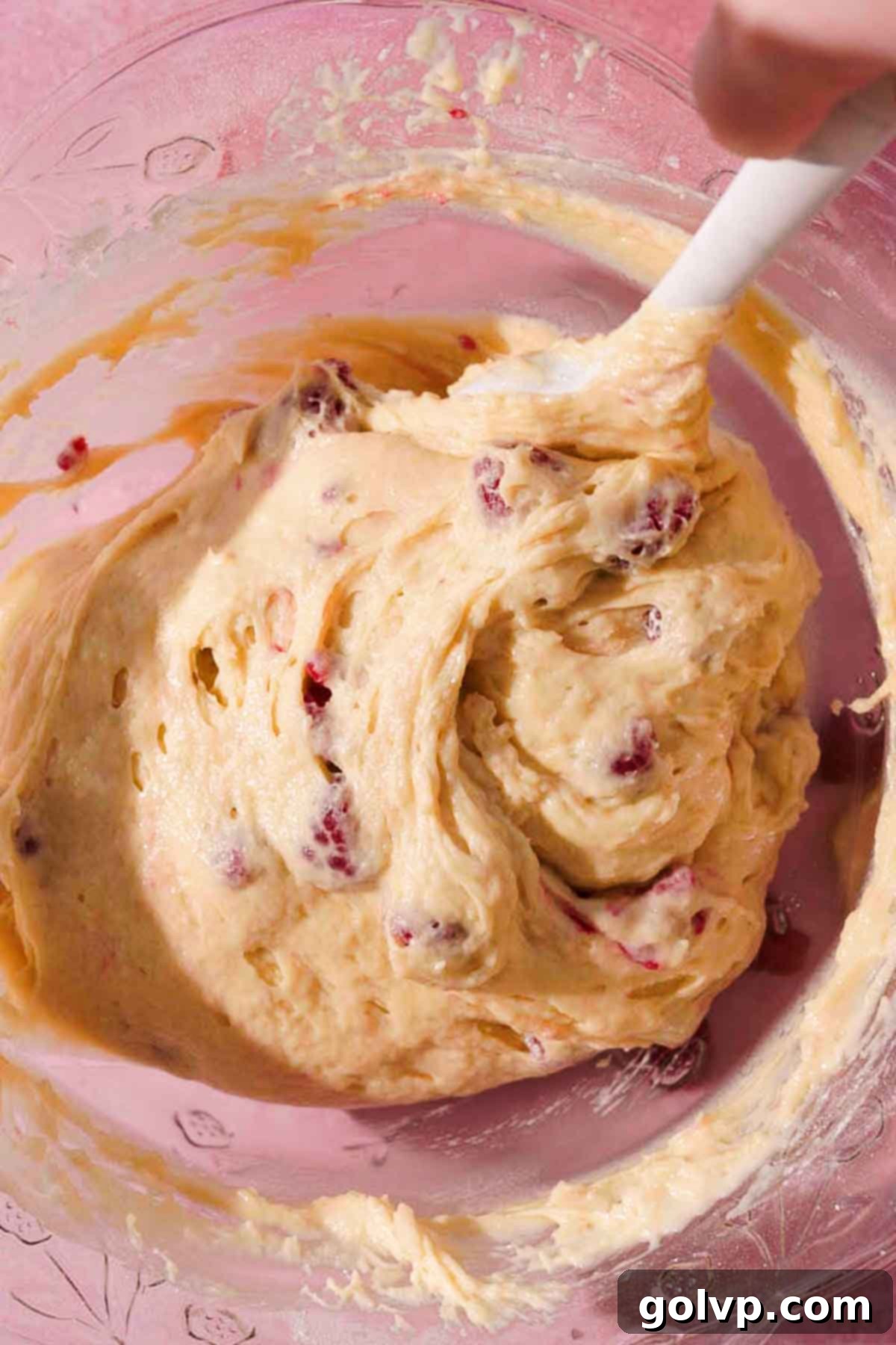folding lemon raspberry loaf cake batter with rubber spatula