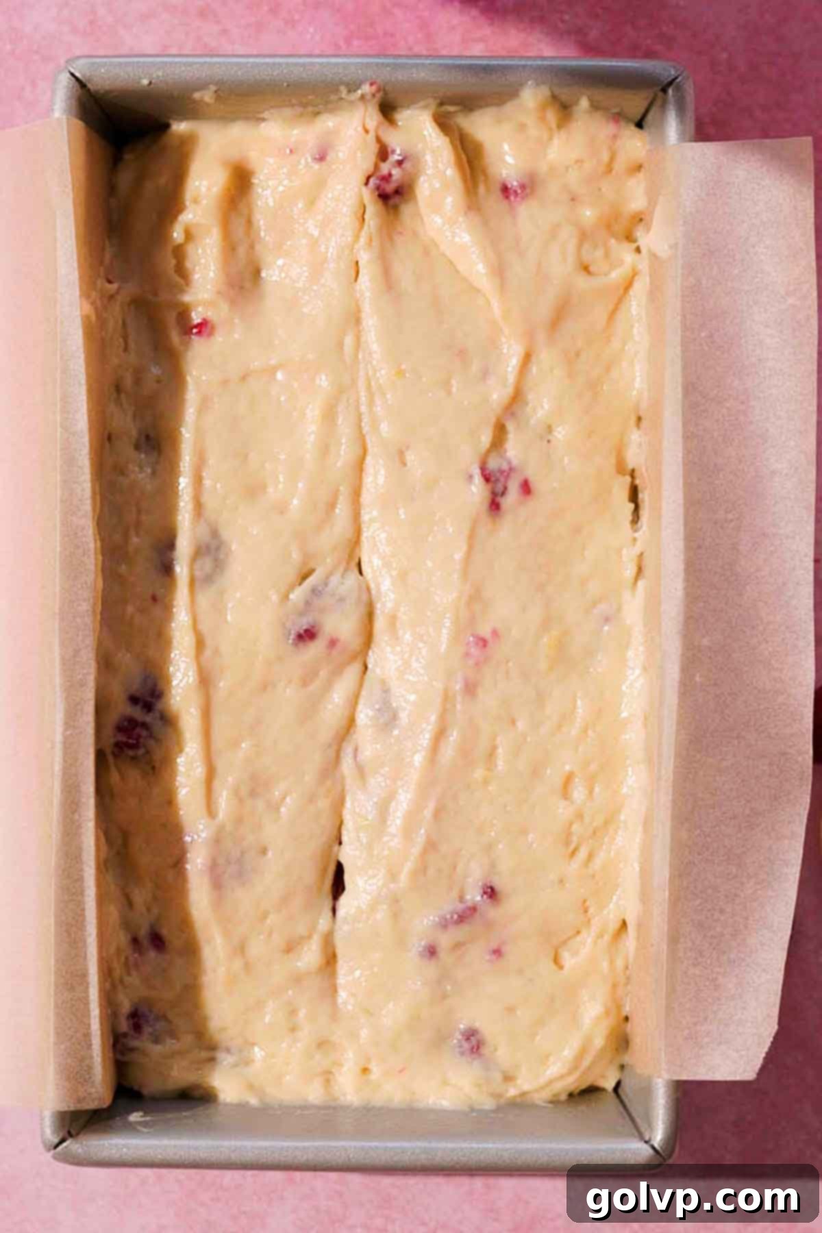 lemon raspberry batter in loaf tin ready to bake