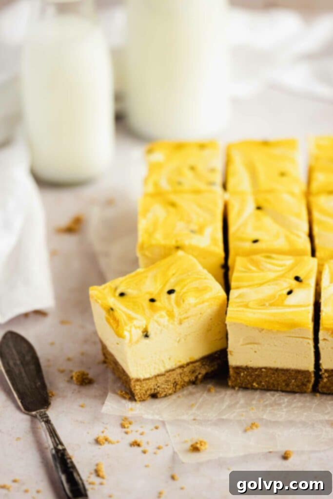 Two slices of no-bake passion fruit cheesecake on a white plate, showing the creamy texture and curd swirls.
