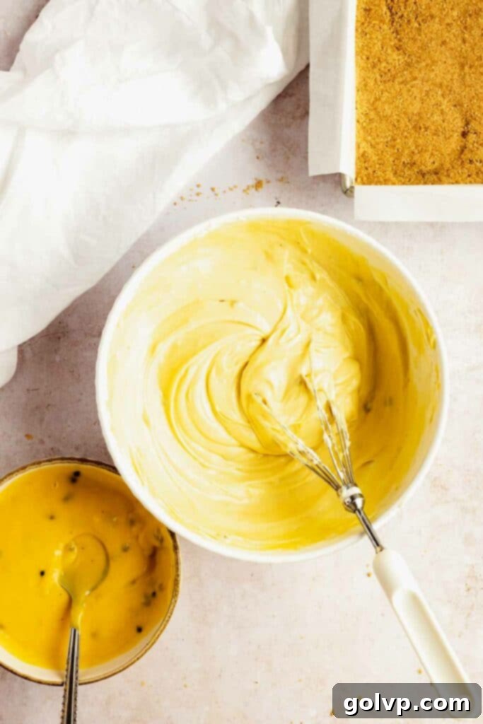 A top-down view of the no-bake passion fruit cheesecake with swirls.
