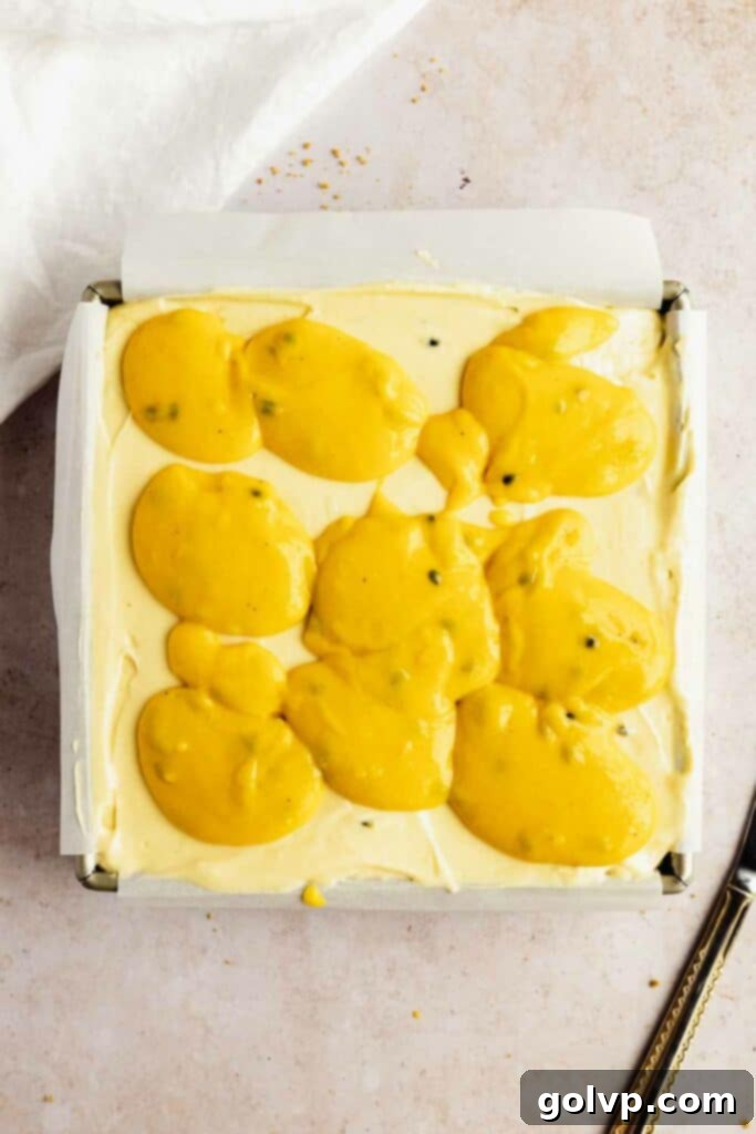 A close-up of the passion fruit curd swirls on the cheesecake.