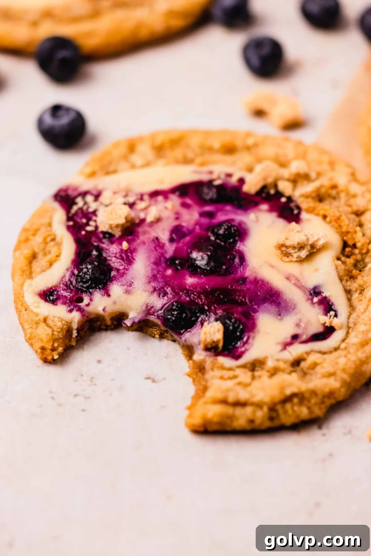 bitten cookie with blueberry cheesecake swirled filling