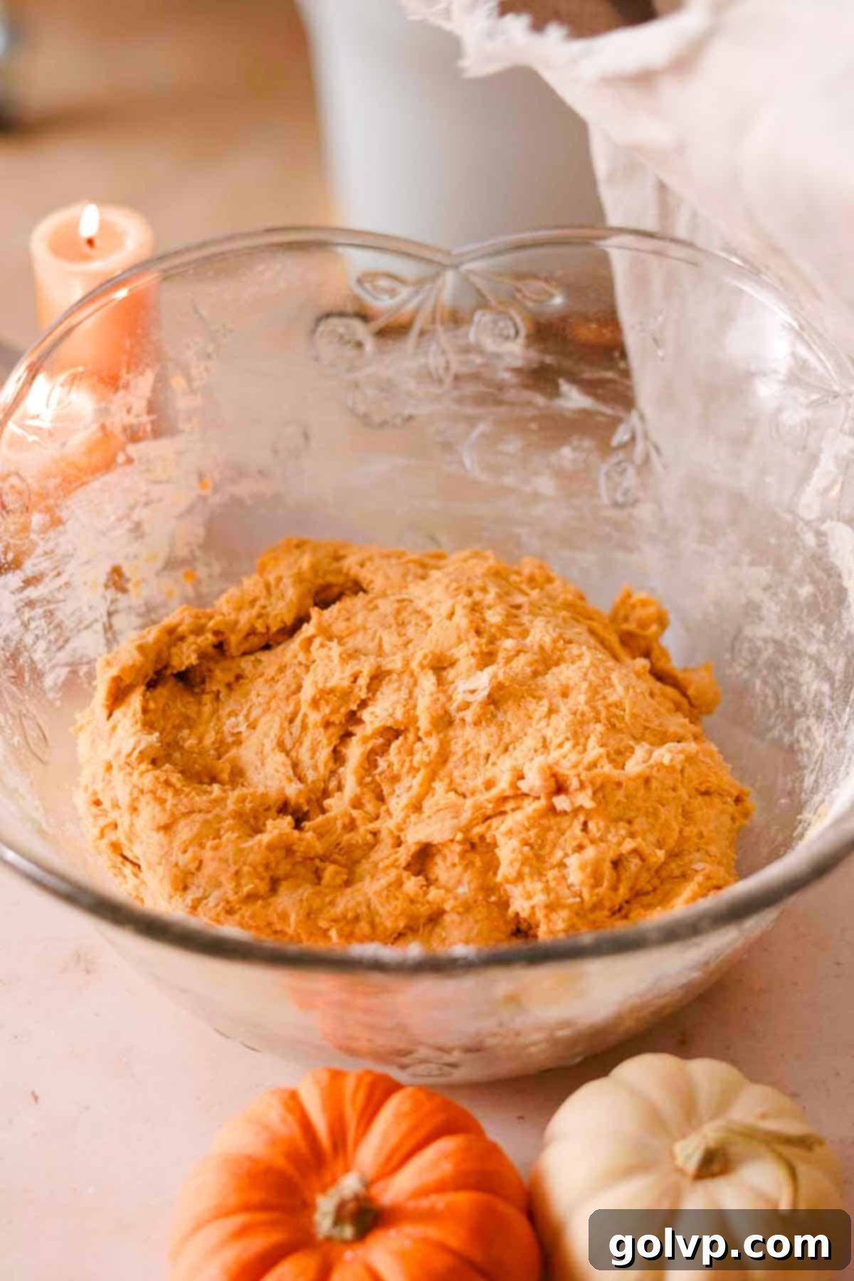 the mixed donut dough in glass bowl ready to rise